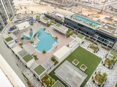 an aerial view of a building with a swimming pool at FIRST CLASS 2BR Classy Getaway Near Downtown in Dubai