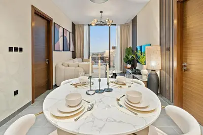 a dining room with a white table and chairs at FIRST CLASS 2BR Classy Getaway Near Downtown in Dubai