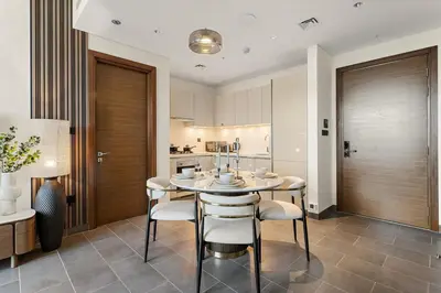 a kitchen and dining room with a table and chairs at FIRST CLASS 2BR Classy Getaway Near Downtown in Dubai