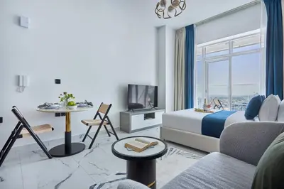 a hotel room with a bed and a table and a tv at Frank Porter - Opalz by Danube in Dubai