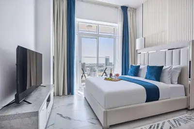 a bedroom with a large bed and a television at Frank Porter - Opalz by Danube in Dubai
