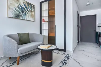 a living room with a chair and a table at Frank Porter - Opalz by Danube in Dubai