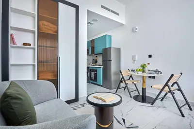a kitchen and a living room with a couch and a table at Frank Porter - Opalz by Danube in Dubai