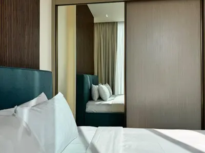 a hotel room with a bed and a mirror at Brand New 1BDR with Large Terrace 4 Guests in Dubai