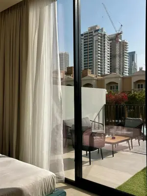 a bedroom with a balcony with a view of a city at Brand New 1BDR with Large Terrace 4 Guests in Dubai
