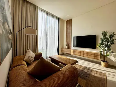 a living room with a couch and a flat screen tv at Brand New 1BDR with Large Terrace 4 Guests in Dubai