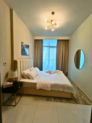 a bedroom with a large bed and a window at Canal View - 10 Minutes Walk to Dubai Mall in Dubai