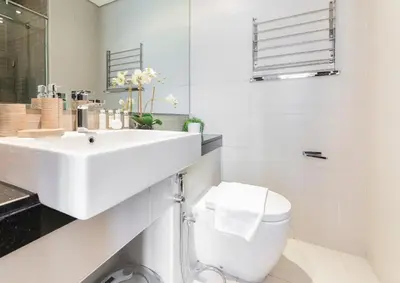 a white bathroom with a sink and a toilet at Silverene Tower A, Dubai Marina - Mint Stay in Dubai