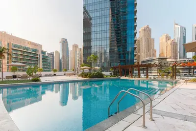 a swimming pool in a city with tall buildings at Silverene Tower A, Dubai Marina - Mint Stay in Dubai