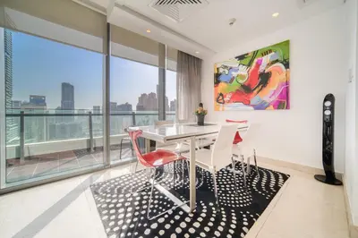 a dining room with a table and chairs and a large window at Silverene Tower A, Dubai Marina - Mint Stay in Dubai