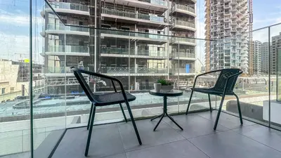 two chairs and a table in front of a window at Stylish Studio with Modern Comfort & Luxury - 2AB06 in Dubai