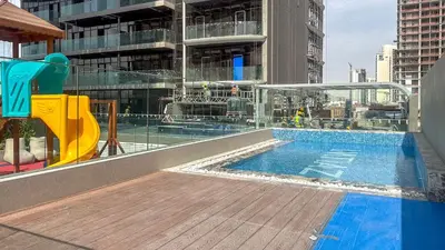 a swimming pool on the roof of a building at Stylish Studio with Modern Comfort & Luxury - 2AB06 in Dubai