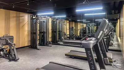 a gym with a treadmill and other equipment in it at Stylish Studio with Modern Comfort & Luxury - 2AB06 in Dubai