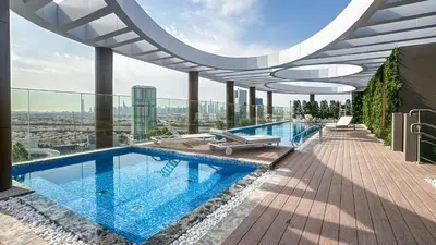 a swimming pool on the roof of a building at Stylish Studio with Modern Comfort & Luxury - 2AB06 in Dubai
