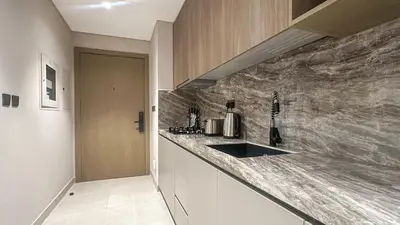 a kitchen with a sink and a counter top at Stylish Studio with Modern Comfort & Luxury - 2AB06 in Dubai