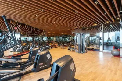 a gym with rows of treadmills and elliptical machines at Burj Khalifa view cozy studio in Dubai