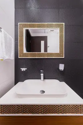 a bathroom with a white sink and a mirror at Burj Khalifa view cozy studio in Dubai