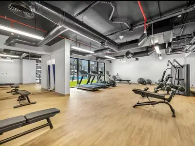 a gym with treadmills and exercise equipment in a room at Modern & Cozy JVC Studio Couple or Solo in Dubai