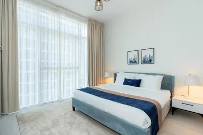 a bedroom with a large bed and a large window at CitiHome - Spacious 2BR - Park Gate Residences in Dubai