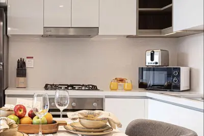 a kitchen with a table with fruit and wine glasses at Luxurious Burj Vista Apartment with Burj Khalifa view in Downtown Dubai in Dubai