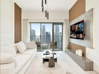 a living room with a white couch and a large window at Luxurious Burj Vista Apartment with Burj Khalifa view in Downtown Dubai in Dubai