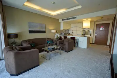 a living room with two couches and a kitchen at EMAAR Residences Fashion Avenue 1BHK by WS Holiday Homes in Dubai