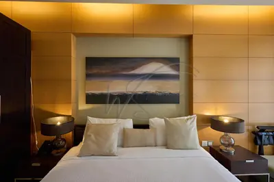 a bedroom with a large white bed with two lamps at EMAAR Residences Fashion Avenue 1BHK by WS Holiday Homes in Dubai