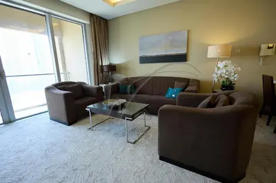 a living room with two couches and a table at EMAAR Residences Fashion Avenue 1BHK by WS Holiday Homes in Dubai