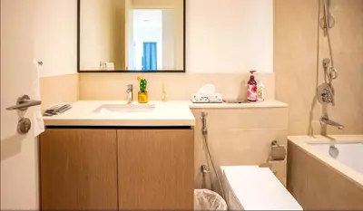 a bathroom with a sink and a mirror and a tub at High Rise Building in Burj Vista with Burj Khalifa View in Dubai