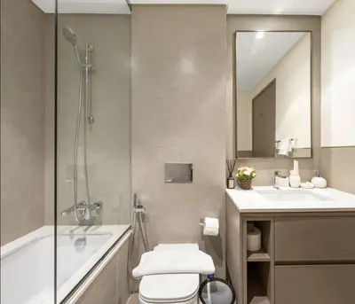 a bathroom with a toilet and a sink and a shower at High Rise Building in Burj Vista with Burj Khalifa View in Dubai