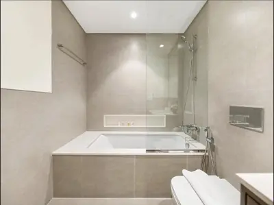 a bathroom with a bath tub and a shower at High Rise Building in Burj Vista with Burj Khalifa View in Dubai