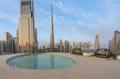 a rooftop pool with a view of the city at have fun with your family and friends in our apt in Dubai