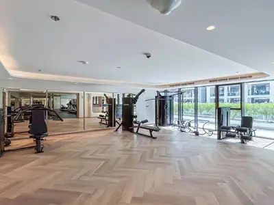 a gym with treadmills and exercise equipment in a building at Stylish City Studio with Balcony View in Meydan in Dubai