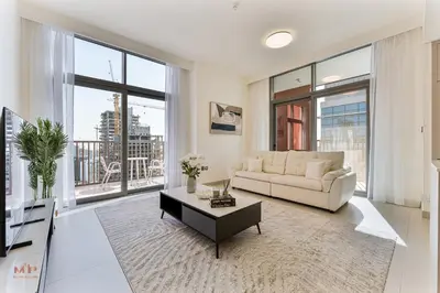 a living room with a couch and a table at Executive 1BR at Hadley Heights, JVC Dubai with balcony City Views in Dubai
