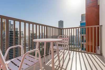 a balcony with a table and chairs and a city at Executive 1BR at Hadley Heights, JVC Dubai with balcony City Views in Dubai