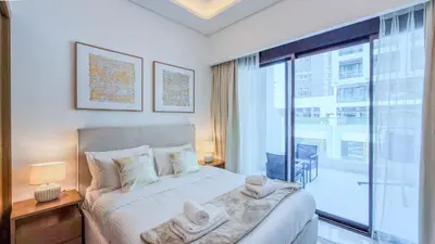 a bedroom with a bed and a large window at TRPS - Azizi RIviera 63, Al Meydan - Brand New Studio, Modern Furnished, Excellent Amenities in Dubai