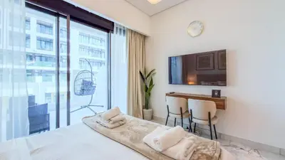 a bedroom with a bed and a large window at TRPS - Azizi RIviera 63, Al Meydan - Brand New Studio, Modern Furnished, Excellent Amenities in Dubai