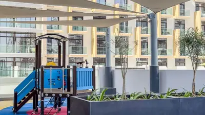 a playground in front of a building at TRPS - Azizi RIviera 63, Al Meydan - Brand New Studio, Modern Furnished, Excellent Amenities in Dubai