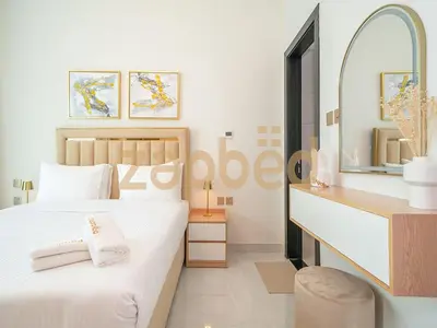 a white bedroom with a bed and a mirror at Stylish 2BR Apartment Skyz By Danube Arjan in Dubai