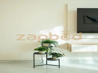 two potted plants on a stand in front of a sign at Stylish 2BR Apartment Skyz By Danube Arjan in Dubai