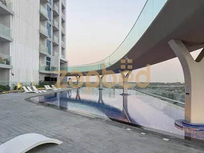 a view of a building with a swimming pool at Stylish 2BR Apartment Skyz By Danube Arjan in Dubai
