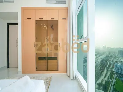 a room with a glass door in a building at Stylish 2BR Apartment Skyz By Danube Arjan in Dubai