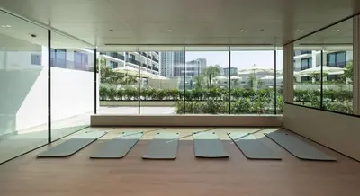 a large room with large windows and a floor with mats at Premium Studio W Pool & Gym Binghatti Aurora in Dubai