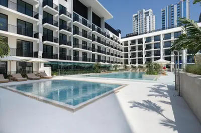 a swimming pool in front of a building at Premium Studio W Pool & Gym Binghatti Aurora in Dubai