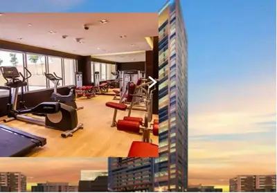 a gym with exercise equipment and a tall building at Exquisite Lavish Studio in Ghalia JVC -16 in Dubai