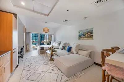 a living room with a couch and a table at Daniels Studio with Lake View in JLT in Dubai