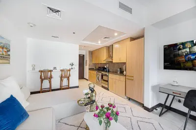 a living room with a couch and a table at Daniels Studio with Lake View in JLT in Dubai