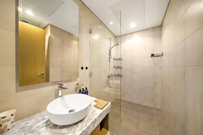 a bathroom with a sink and a shower at Daniels 2BR with Canal View at Aykon City in Dubai
