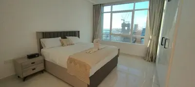 a bedroom with a bed and a large window at Silk Valley - Luxury 1BR: Steps to Barasti Beach & Marina Walk in Dubai