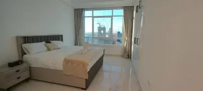 a bedroom with a bed and a large window at Silk Valley - Luxury 1BR: Steps to Barasti Beach & Marina Walk in Dubai